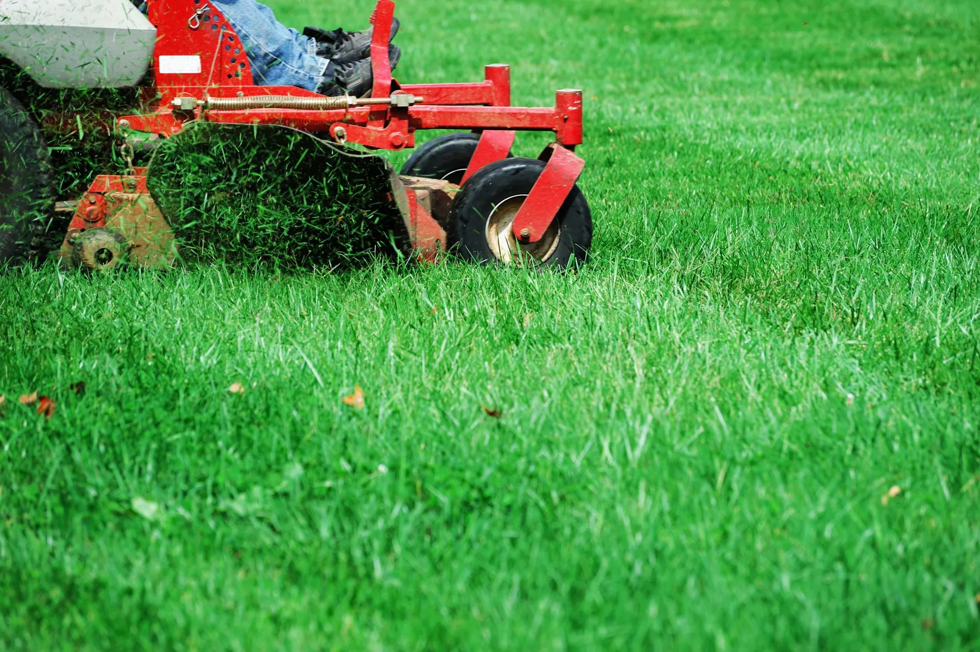 Lawn care equipment in action on a residential property
